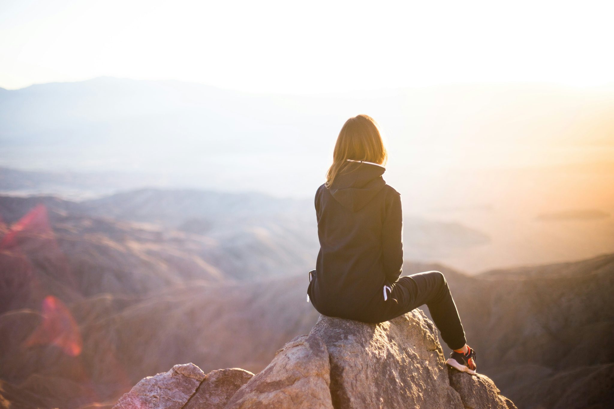 Acceptance and commitment therapy. Woman on top of a mountain