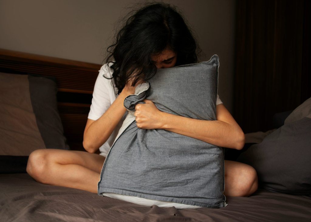 Sexual violence counselling. Girl crying into pillow
